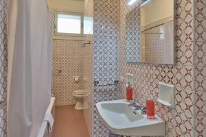a bathroom with a sink and a toilet at Villa Lucy - Lake view in Varenna +31 photos