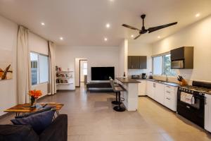 a kitchen and living room with a couch and a table at Pazifico Villas in Playa Avellana
