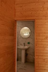 a bathroom with a sink and a mirror at Guest House Adelina in Mestia
