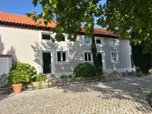 a white house with a red roof at PiuPiuStays in Vermelho