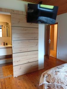 a bedroom with a large wooden wall at Studio pr Vok in Lesce