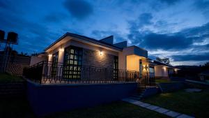 a house with lights on the front of it at night at Bella Vista Villas Ltd in Mbarara