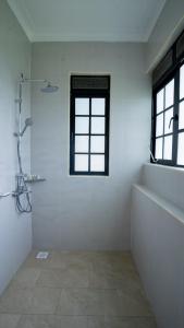 a white bathroom with a shower and a window at Bella Vista Villas Ltd in Mbarara +25 photos