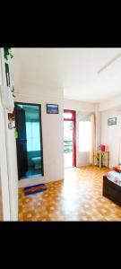 a living room with a large mirror and a wooden floor at ML 12 HomeStay in Jakrem
