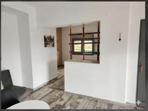 a living room with white walls and a window at Olea Heaven Aliveri in Aliveri