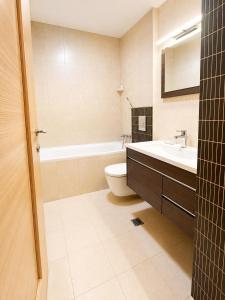 a bathroom with a sink and a toilet and a tub at HERASTRAU APARTMENTS 3 camere self check-in in Bucharest +25 photos