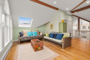 a living room with two couches and a table at Robbins Nest in Essex