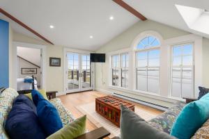 a living room with a couch and windows at Robbins Nest in Essex