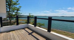 a balcony with a view of the water at Robbins Nest in Essex