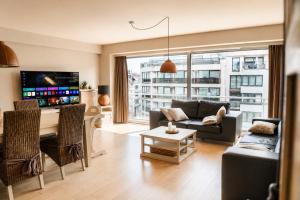 a living room with a couch and a table at Vertry at Sea, Luxury Apartment Knokke in Knokke-Heist