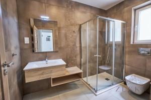 a bathroom with a shower and a sink at Large 3BR Flat with Exceptional Marina Views in Tal-Pietà
