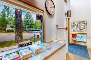 a clock on a wall next to a window at Aspen Mountain Lodge in Aspen +20 photos
