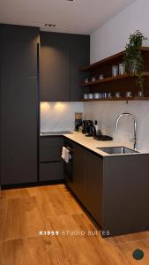a kitchen with a sink and a counter top at K1959 Studio Suites in Peje +21 photos