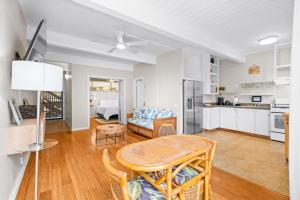 a kitchen and living room with a table and a couch at Kona Mansions#208 in Kailua-Kona