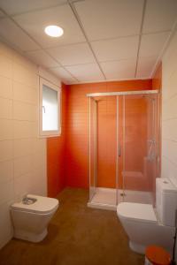 a bathroom with a shower and a toilet and a sink at Casa La Fuente in Chella +8 photos