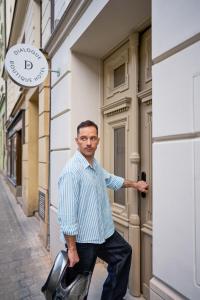 a man is standing outside of a building at DIALOGUE Boutique Hotel in Brno +77 photos