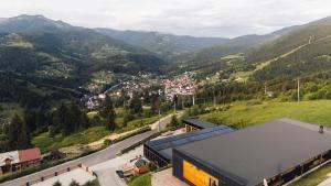 an aerial view of a town in the mountains at Panoramic Residence in Borşa