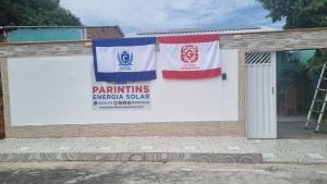 a building with two flags on the side of it at Casapalmares in Parintins