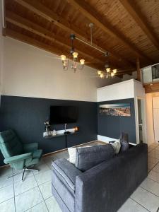 a living room with a couch and a tv at Ferienwohnung Loft ca. 45 qm in Anröchte