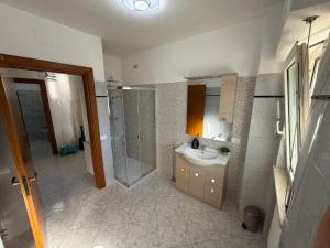 a bathroom with a sink and a shower and a mirror at Casa Dulce Casa - Bright flat with balcony 2 baths 2 beds in Scafa +35 photos