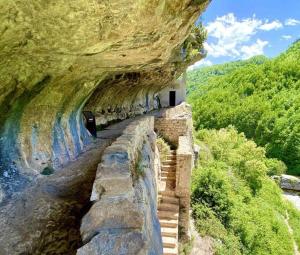 a staircase in a cliff next to a river at Casa Dulce Casa - Bright flat with balcony 2 baths 2 beds in Scafa