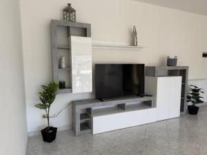 a living room with a flat screen tv on a wall at Casa Dulce Casa - Bright flat with balcony 2 baths 2 beds in Scafa