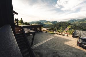 a balcony of a building with a view of mountains at Panoramic Residence in Borşa