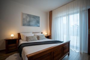a bedroom with a bed and a large window at Villa Elida with Heated Pool - Central Istria in Pazin