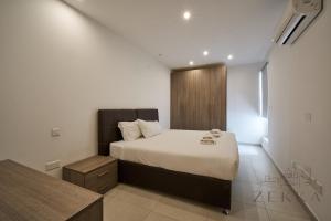 a bedroom with a large bed in a room at Beautiful View, 3 Bedroom Spacious Apartment in Tal-Pietà