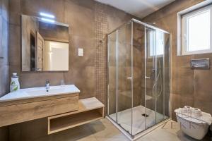 a bathroom with a shower and a sink and a toilet at Beautiful View, 3 Bedroom Spacious Apartment in Tal-Pietà