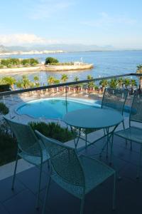 a patio with a table and chairs overlooking the ocean at Vila Inheritor in Shëngjin