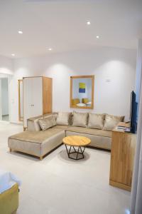 a living room with a couch and a table at Vila Inheritor in Shëngjin