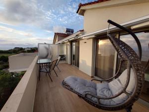 a hammock on the balcony of a house at Ionian Moon 1 in Preveza