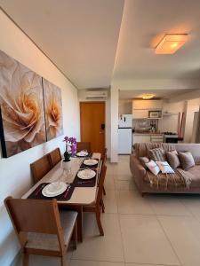 a living room with a table and a couch at Vista Panorâmica • Premium in Palmas