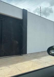 a view of a building with a large glass door at Sua casa longe de casa in Anápolis