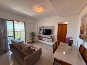 a living room with a couch and a table at Vista Panorâmica • Premium in Palmas