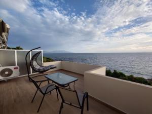 a balcony with a table and chairs and the ocean at Ionian Moon 2 in Preveza