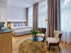 a hotel room with a bed and a table at DIALOGUE Boutique Hotel in Brno
