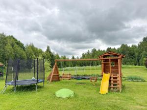 a playground with a play set and a swing at Junkuri Holiday House 9 Beds up to 20 Guests in Jeroškina