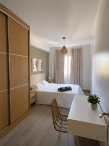 a hotel room with a bed and a chair at Pool&River Villa in Alcoutim