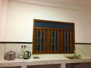 a kitchen counter with a window above a sink at Dil villa in Habaraduwa Central