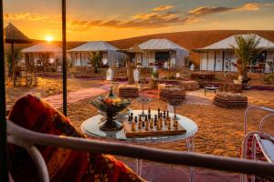a chess game on a table in front of a resort at Aladdin merzouga camp in Merzouga