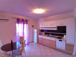 a kitchen with a table and a table and a dining room at Apartmani Blažević in Zaglavice +16 photos