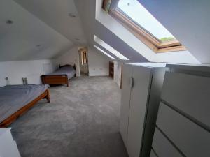 a attic bedroom with a bed and a window at Sea Loft in Shankill