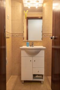 a bathroom with a white sink and a mirror at Luz's Retreat Apartment in Ponta Delgada +15 photos