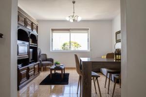 a kitchen and dining room with a table and chairs at Luz's Retreat Apartment in Ponta Delgada