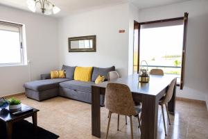 a living room with a couch and a table at Luz's Retreat Apartment in Ponta Delgada