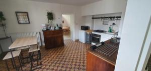 a kitchen with a table and a counter top at Gite des pecheurs, Gorges du Tarn in Mostuéjouls