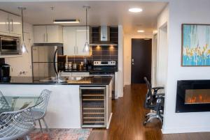 a kitchen with a counter and chairs in a room at Gorgeous Unit with City Views in Vancouver +21 photos