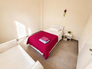 a white bedroom with a bed with a red blanket at Andromeda Sea View Villa in Epáno Eloúnda +46 photos